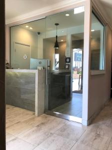 a glass door leading into a kitchen with a counter at Berkshire Motor Hotel in San Diego