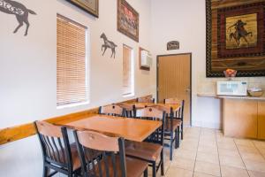 a dining room with a wooden table and chairs at Super 8 by Wyndham Abilene KS in Abilene