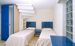 two beds in a room with blue and white walls at Side Garden Residence in Side