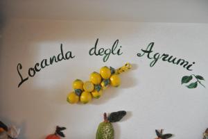 a sign with a bunch of fruit on a wall at Locanda Degli Agrumi in Conca dei Marini