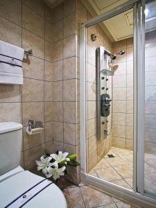 a bathroom with a shower with a toilet at Kao Yuan Hotel - Zhong Shan in Taichung