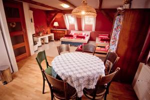 a dining room with a table and chairs at Penzion PIŠLIKDUM in Stará Červená Voda