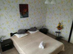 a bedroom with a bed with two pillows on it at Kalbakas Apartamenti in Smiltene