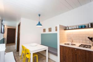 a kitchen with a small table and yellow chairs at Il Viottolo in Noci