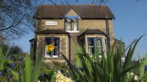 a house with a yellow flower in front of it at River Hotel in Oxford