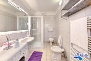 a white bathroom with a sink and a toilet at Residence Venice in Quarto dʼAltino +68 photos