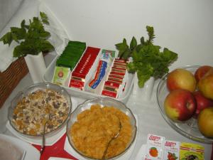 a table with bowls of food and apples on it at Pension Schottentor in Vienna