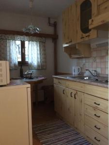 a kitchen with wooden cabinets and a sink at Apartma Gracner in Bled