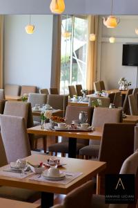 a restaurant with tables and chairs with food on them at Hotel Santa Maria in Saint-Florent