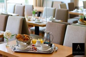 a tray of food on a table with coffee and pastries at Hotel Santa Maria in Saint-Florent