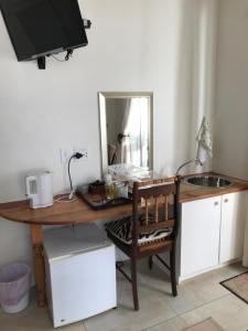 a wooden desk with a mirror and a sink at B&B@9.Libertas in Stellenbosch