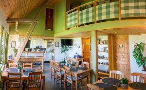 a dining room with wooden tables and chairs at Mattisgården Bed & Breakfast in Östra Ljungby