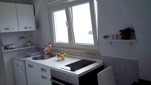 a small kitchen with a sink and a window at Apartment Luna in Dubrovnik