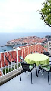 a table and chairs on a balcony with a view at Apartment Luna in Dubrovnik