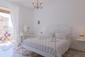 Posteľ alebo postele v izbe v ubytovaní Maison Ortigia