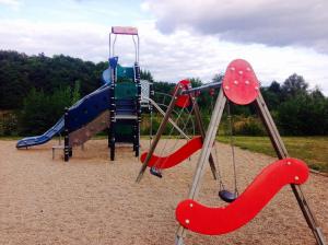 a playground with a slide and a swing set at Dugny-Mobil home in Onzain