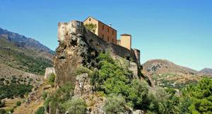 a castle on the top of a mountain at Les Bergeries "Le figuier" in Omessa +35 photos