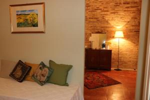 a living room with a couch with pillows on it at La Casa Sul Borgo in Lapedona