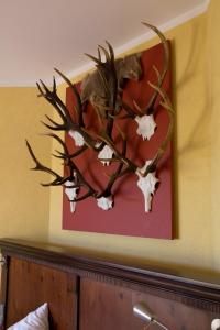 a painting of a stag with antlers on a wall at Hotel Hirsch in Rothenberg