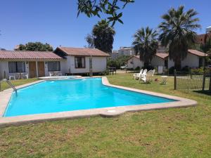 a swimming pool in the yard of a house at MarSerena in La Serena