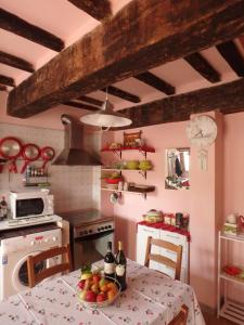 a kitchen with a table with a bowl of fruit on it at The Four Angels in Massa