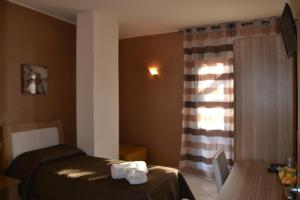 a room with two beds and a table and a window at Villa Sofia in Parghelia +69 photos