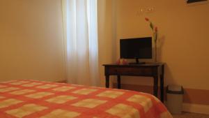 a bedroom with a bed and a tv on a table at L'ulivo Chiantigiana 115 in Florence
