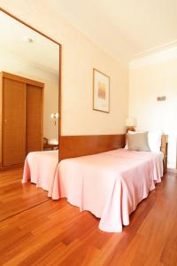 Postel nebo postele na pokoji v ubytování Hotel Abbazia