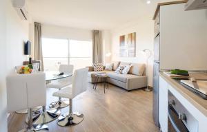 a living room with a couch and a table at Apartment Club Playa Flores in Torremolinos