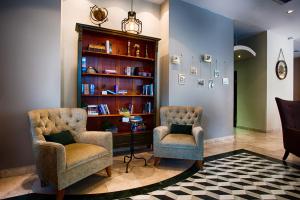 two chairs and a book shelf with books at Eldan Hotel in Jerusalem