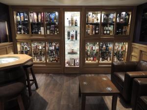 a bar with a lot of bottles of alcohol at The Orkney Hotel in Kirkwall