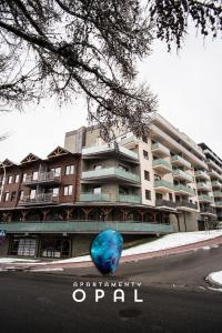 a blue vase sitting in front of a building at Apartamenty Opal in Krynica Zdrój