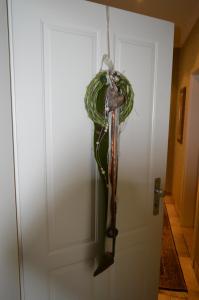 a closed door with a plant hanging from it at Hotel Restaurant Gerwing-Wulf in Alstätte