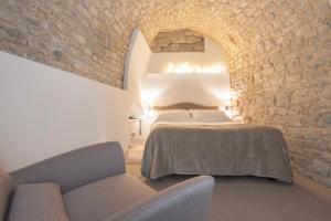 Postel nebo postele na pokoji v ubytování Locanda Don Serafino Historical Boutique Hotel