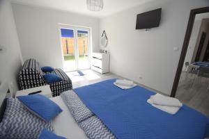 Posteľ alebo postele v izbe v ubytovaní Mazuria Apartamenty
