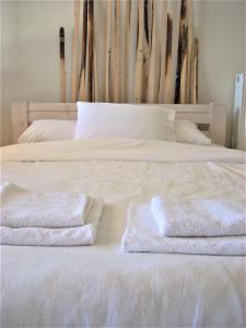 a bed with two towels on top of it at Sea View Suite Methana in Methana