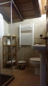 a bathroom with a toilet and a window and a sink at Hostal Chinchon in Chinchón