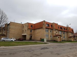 a large brick building on the side of a street at Pretty Apartment in Jelgava