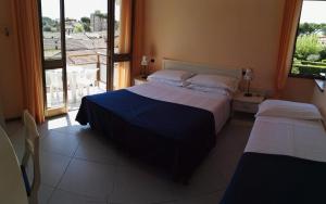 Postel nebo postele na pokoji v ubytování Hotel Elizabeth