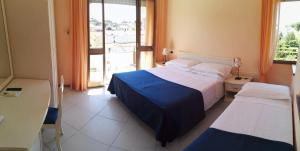 Postel nebo postele na pokoji v ubytování Hotel Elizabeth