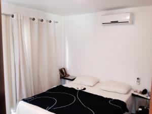 a small room with a bed and a curtain at Dream Village Cumbuco Beach in Cumbuco +23 photos