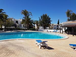 a swimming pool with two lounge chairs next to it at Perfect Holidays - Sao Rafael in Sesmarias