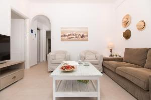 a living room with a couch and a table at Villa Maria Naxos in Naxos Chora