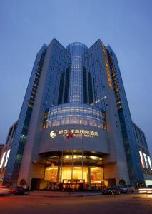 a large building with a sign on the front of it at WuHu XingBai JinLing Hotel in Wuhu