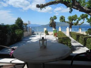 a table with a light on it next to the water at Mamanis Studios in Loutra Edipsou