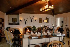 a living room with a couch and a fireplace at Ngamihi Lodge in Rotorua