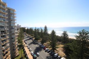 a beach with a lot of cars parked in front of it at Oceania on Burleigh Beach in Gold Coast