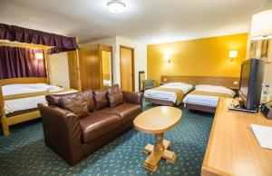 A bed or beds in a room at Tollgate Hotel & Leisure 