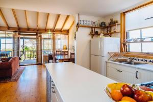 a kitchen with a counter with a bowl of fruit at The Blue Beach House in Quinns Rocks