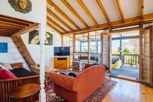 a living room with a couch and a television at The Blue Beach House in Quinns Rocks